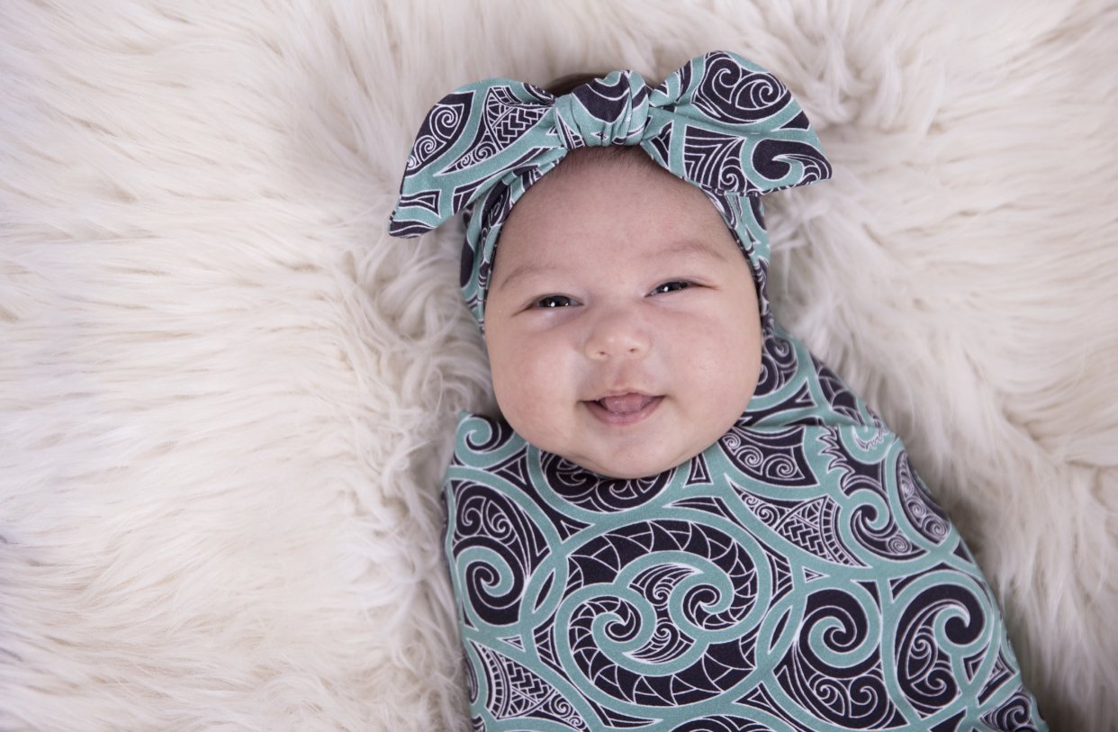 Beautiful baby swaddles using Maori designs from nz clothing company Emere.