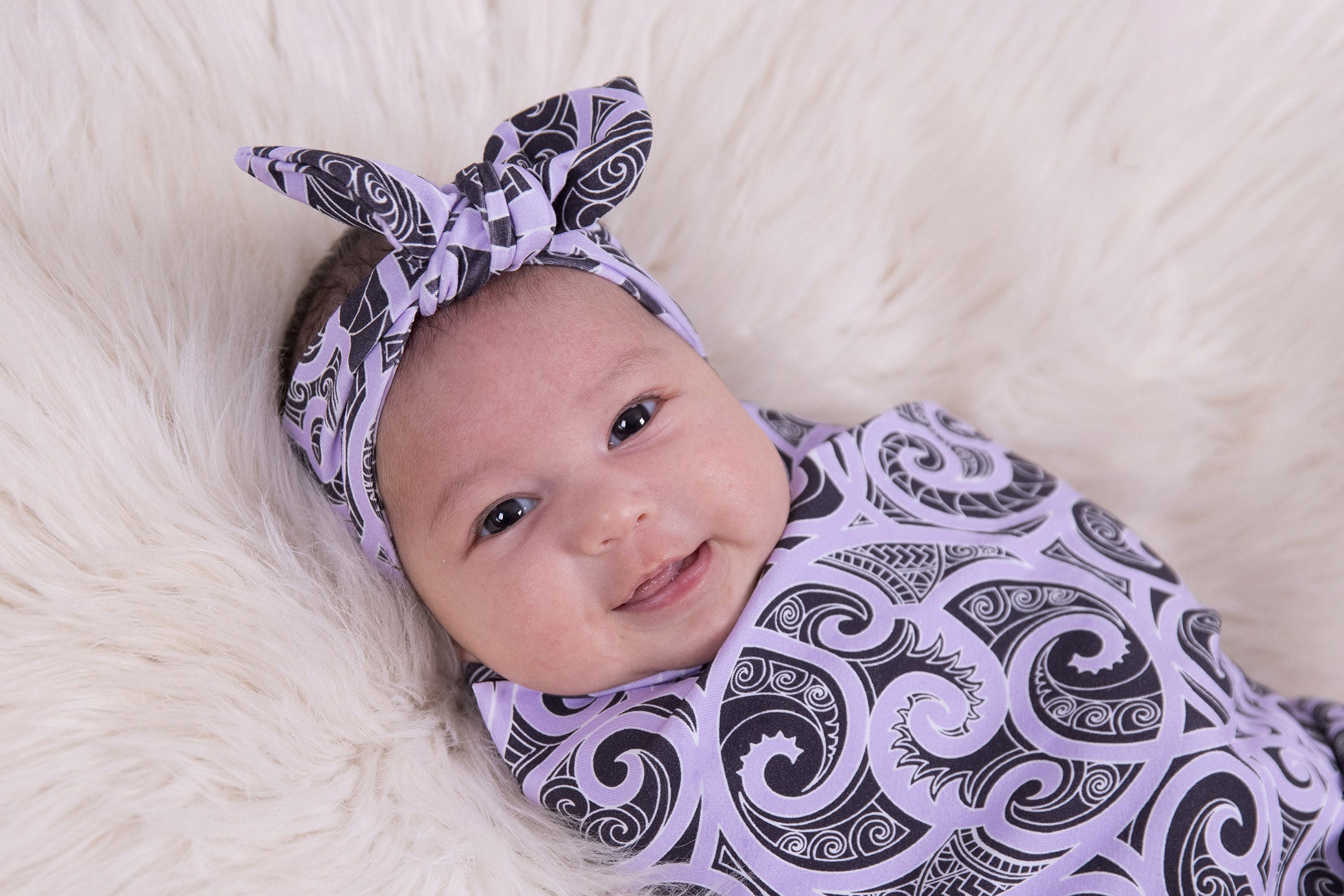 Beautiful baby swaddles using Maori designs from nz clothing company Emere.