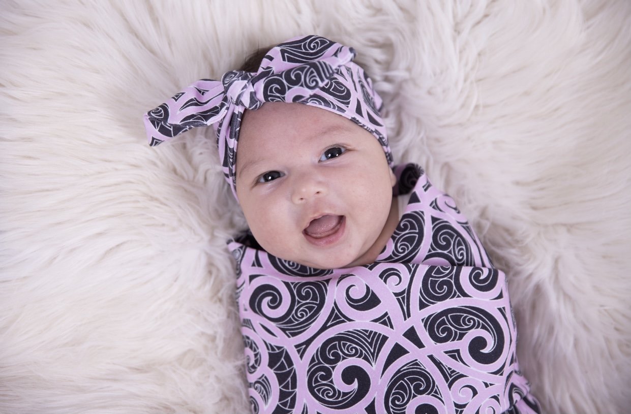 Beautiful baby swaddles using Maori designs from nz clothing company Emere.