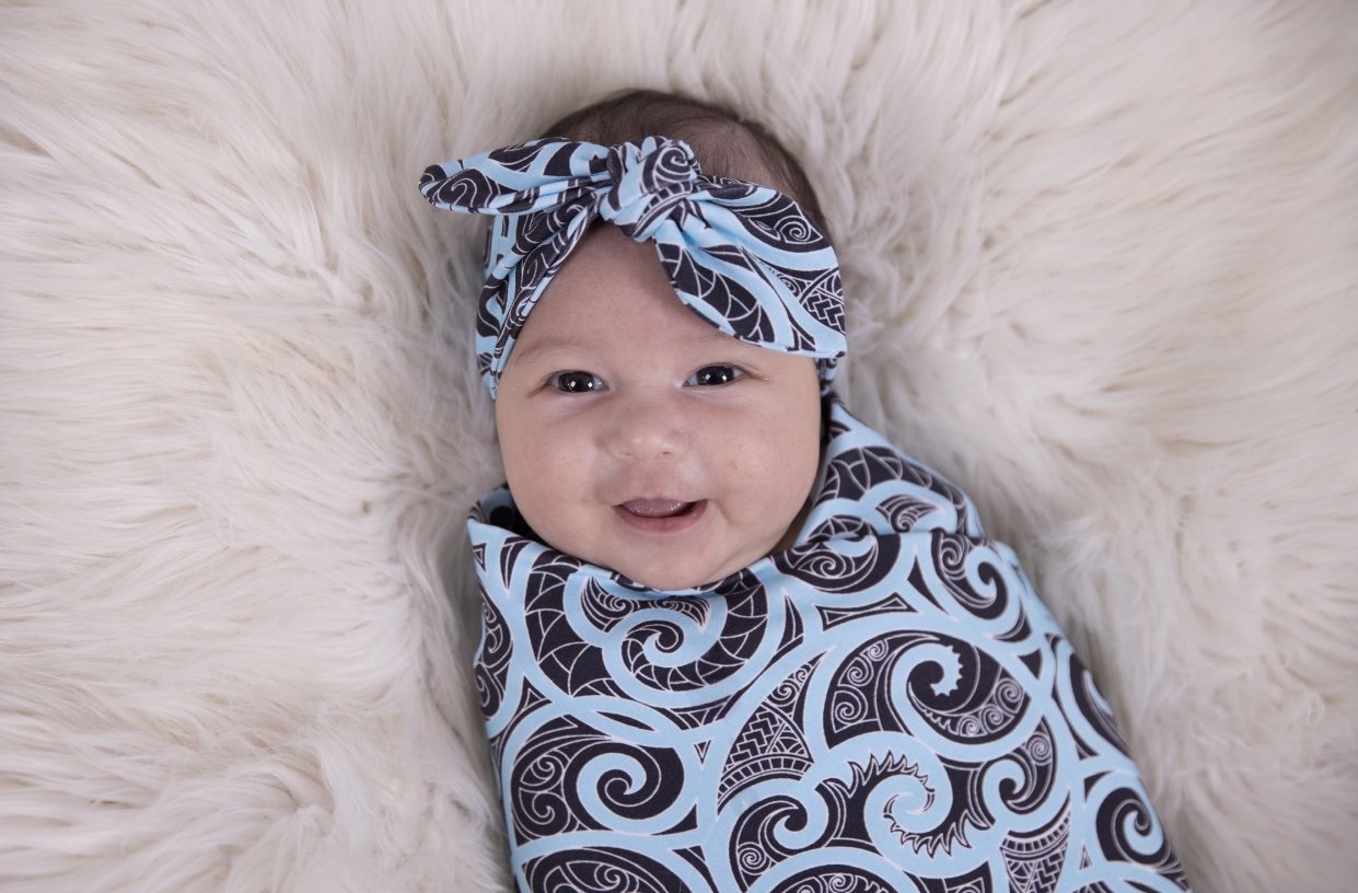 Beautiful baby swaddles using Maori designs from nz clothing company Emere.